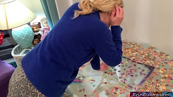 Stepmom is focused on her puzzle but her tits are showing and her stepson fucks her
