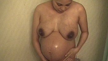 Pregnant asian amateur showering homemade big belly