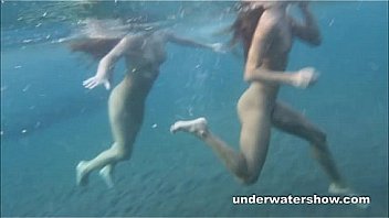 Julia and Masha are swimming nude in the sea