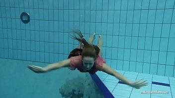 Sexy Russian slut strips in the swimming pool