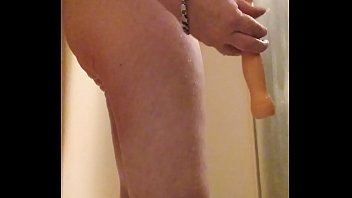 caged gay chub using dildo in shower